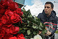 Мужчина кладет цветы у входа в международный аэропорт "Казань" в память о погибших в авиакатастрофе самолета Boeing 737 авиакомпании "Татарстан", разбившегося при посадке.