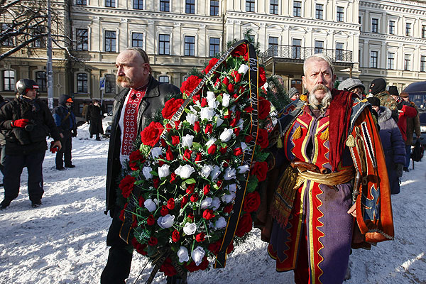 Участники похоронной процессии с венком.