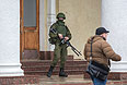 Вооруженный человек у здания аэропорта Симферополя.