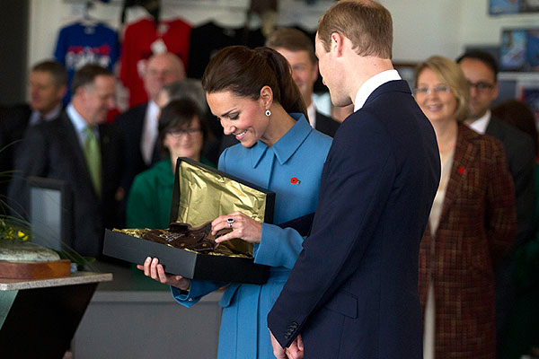 Родители маленького принца рассматривают полученный в Веллингтоне подарок - маленькую летную шапочку для Георга.