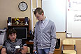 Учитель проверяет паспорт ученика перед сдачей единого государственного экзамена по русскому языку в школе № 1400 Москвы.