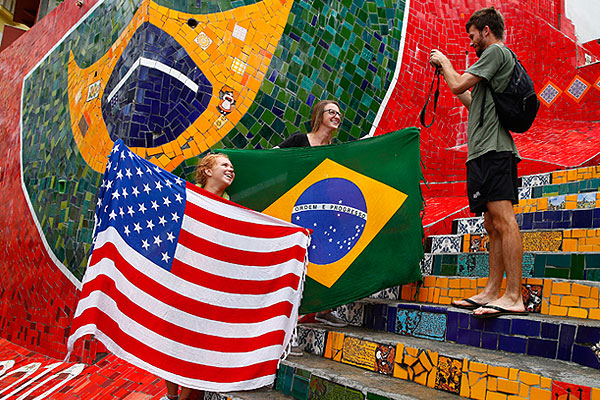 Туристы позируют с американским и бразильским флагами.