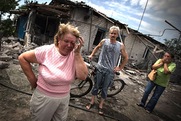 Жители поселка Станица Луганская у разрушенных домов.