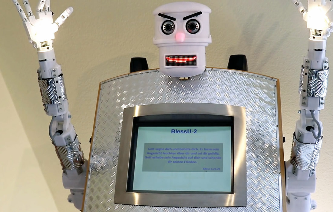 В Евангелической церкви немецкого Виттенберга появился робот-священник разговаривающий на пяти языках. Он может благословить на немецком, английском, французском, испанском и польском языке. Прихожане также могут выбрать между мужским и женским голосом. Робот поднимает руки, вспыхивает огнями, читает библейский стих и по просьбе может предоставить распечатку своих слов.