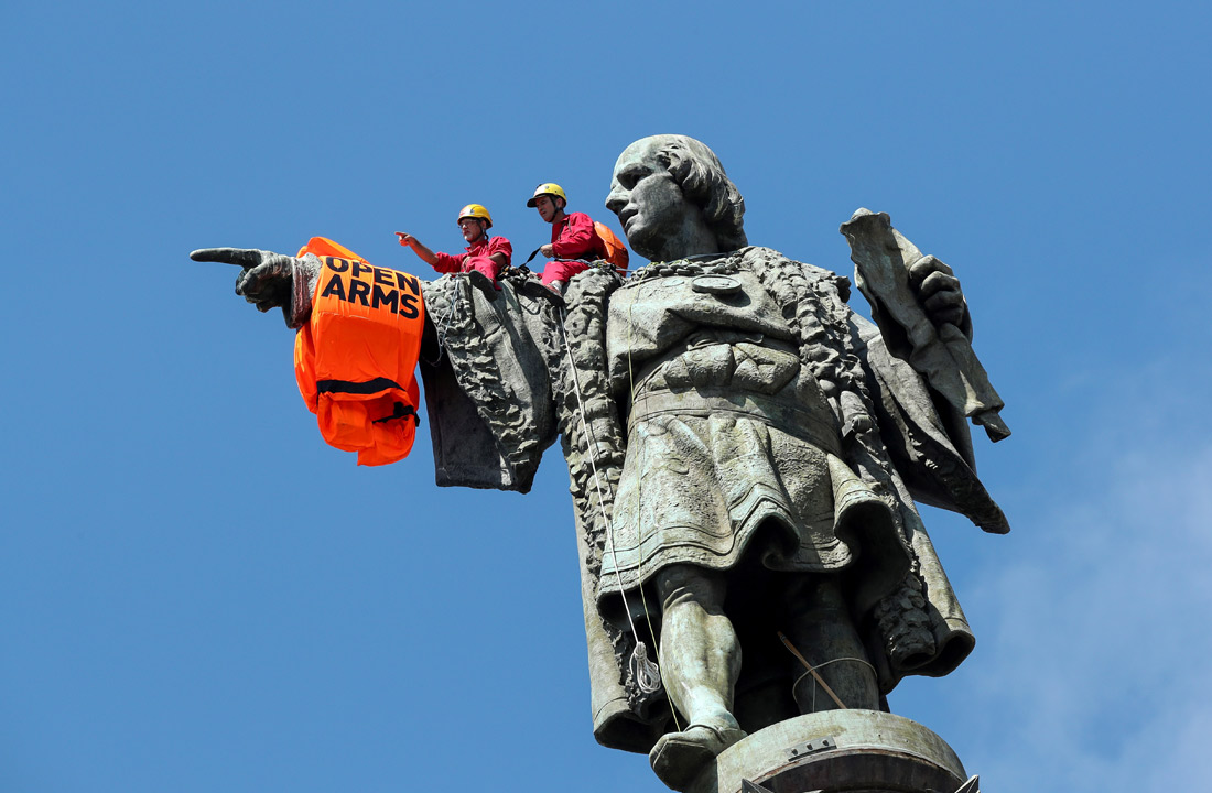 Активисты испанской неправительственной организации Proactiva Open Arms разместили спасательный жилет на статуе Христофора Колумба после того, как судно с 59 мигрантами на борту прибыло в Барселону. Власти Испании разрешили спасательному судну зайти в порт Барселоны после того, как власти Италии и Мальты решительно отказали в заходе в свои гавани.