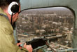 Российский вертолет со стрелком на борту пролетает над столицей Чечни Грозным. 26 января 2000 год.