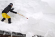 Житель австрийского города Фильцмос убирает снег с крыши дома