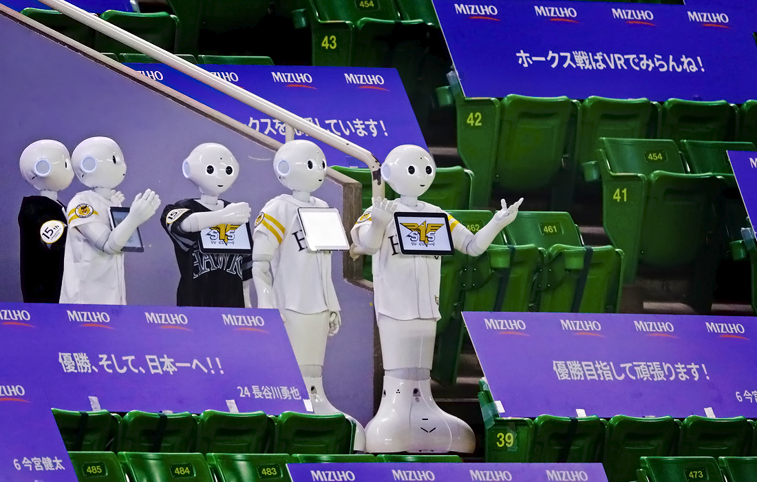 19 июня. Роботы в бейсбольной форме подбадривают игроков перед первым матчем Профессиональной бейсбольной лиги Nippon в японской Фукуоке