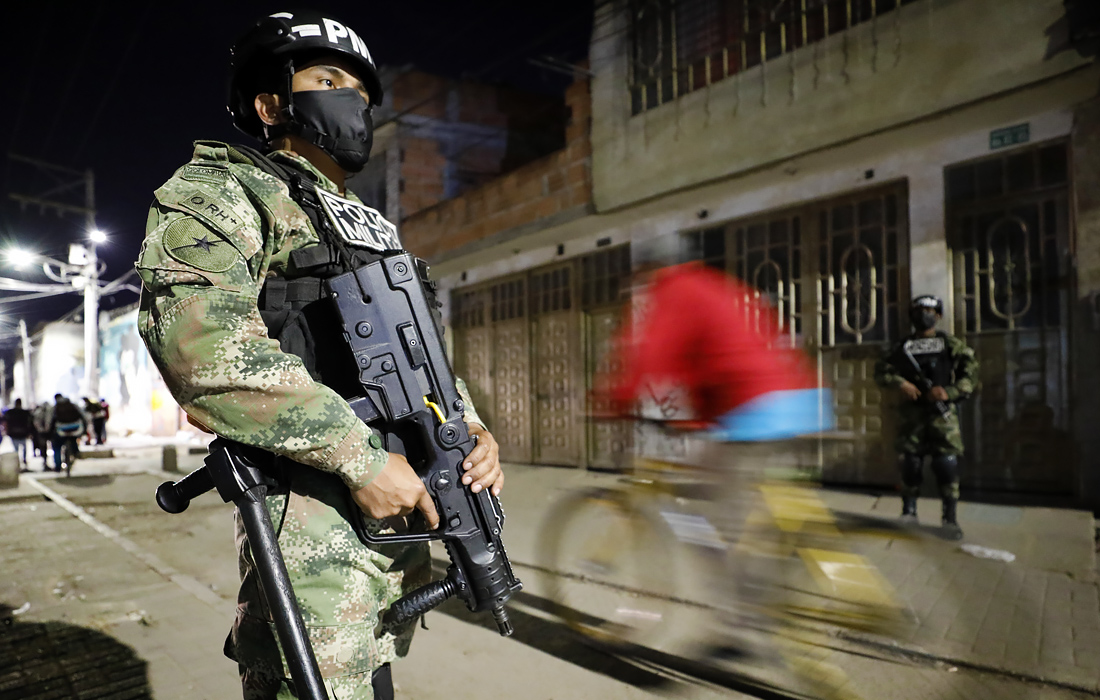 Солдаты охраняют улицу во время комендантского часа, введенного в Боготе, Колумбия