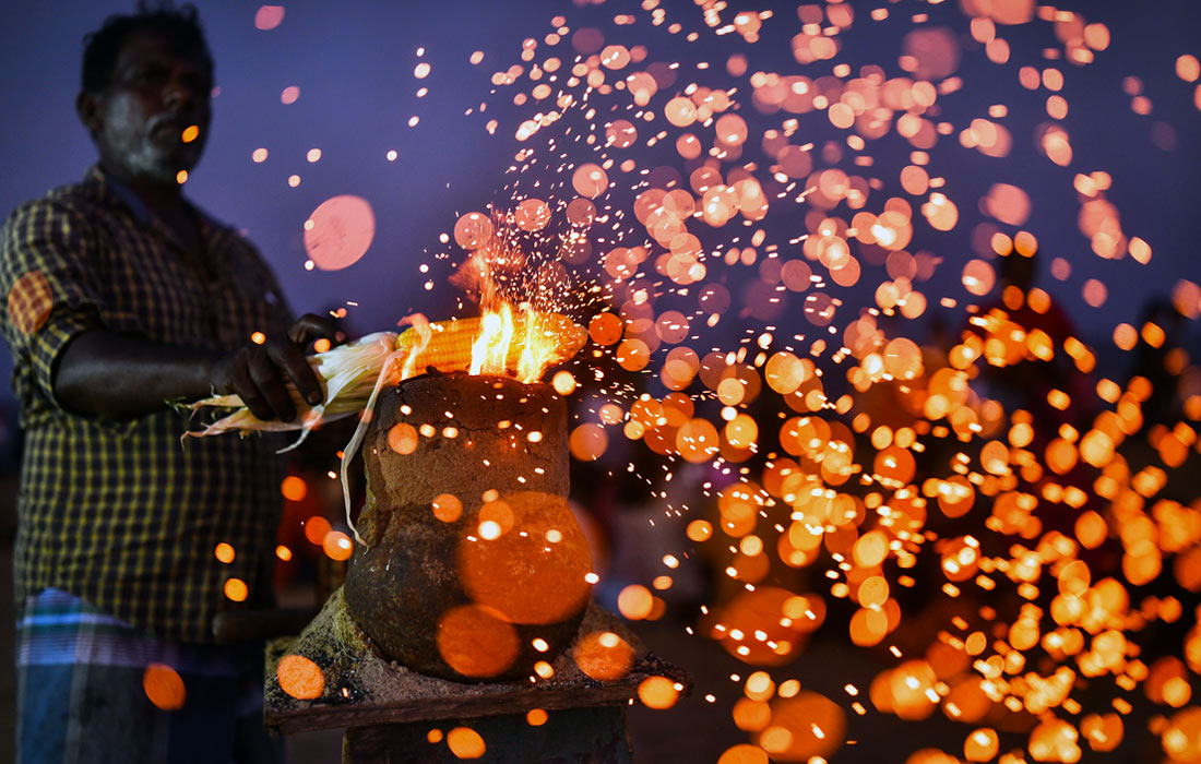 Продавец готовит кукурузу на пляже в Ченнаи, Индия