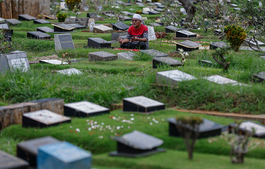Мусульмане посещают кладбища, чтобы почтить память близких перед Рамаданом в Джакарте