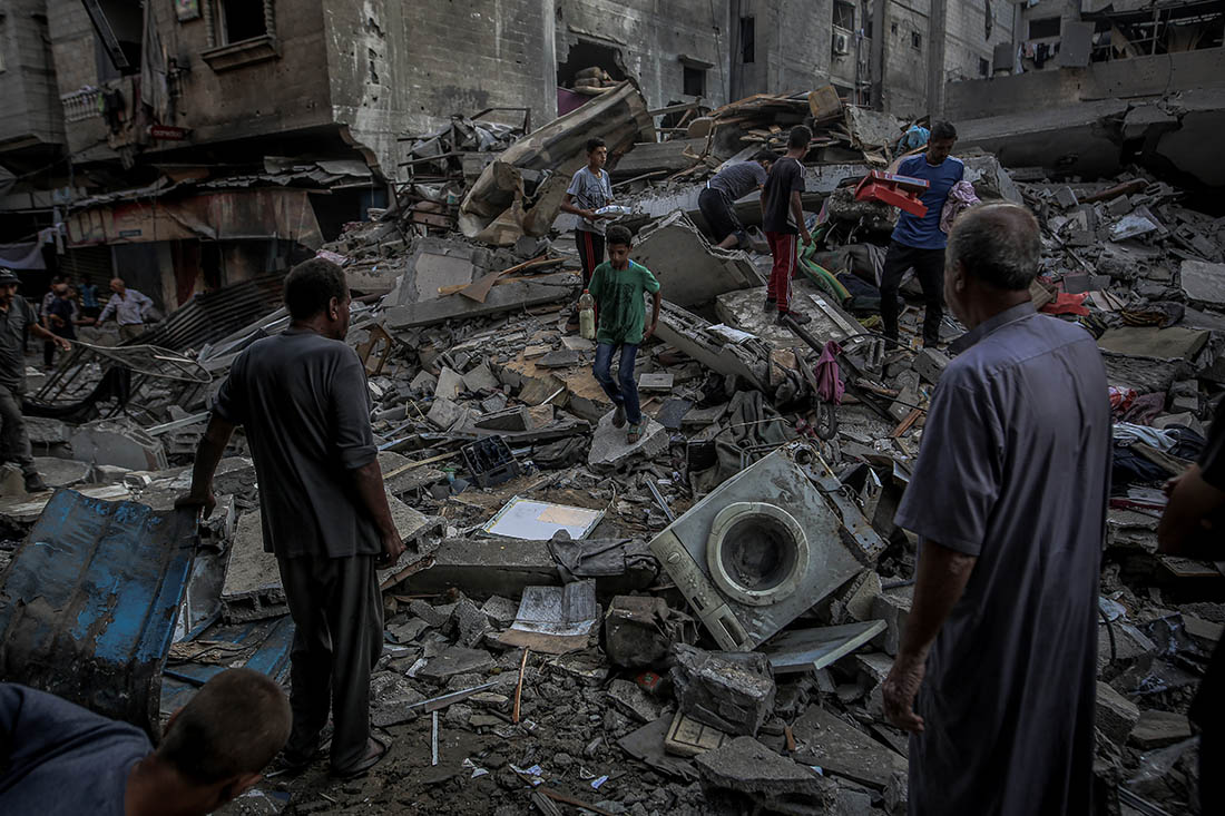 Жители ищут уцелевшие после израильских ударов вещи в Газе