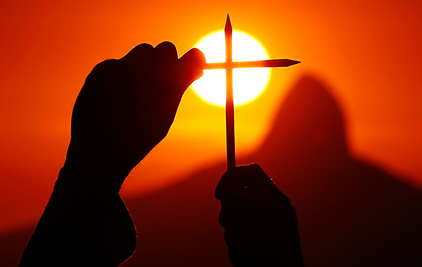 Участник демонстрации складывает карандаши в память о жертвах терракта в редакции Charlie Hebdo